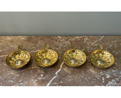 A set of four small silver-gilt tastevins (wine-tasting dishes) with thumb-plate handles and two smaller silver-gilt dishes w