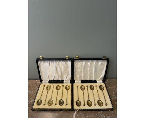 Two sets of six art deco gilded sterling silver and enamel coffee spoons, with seal top finials. The gilding is a deep yellow