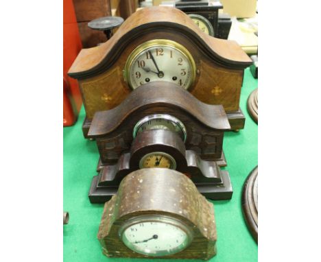 An Edwardian mahogany and inlaid cased mantel clock, a German oak cased mantel clock, a mantel clock with transfer decorated 