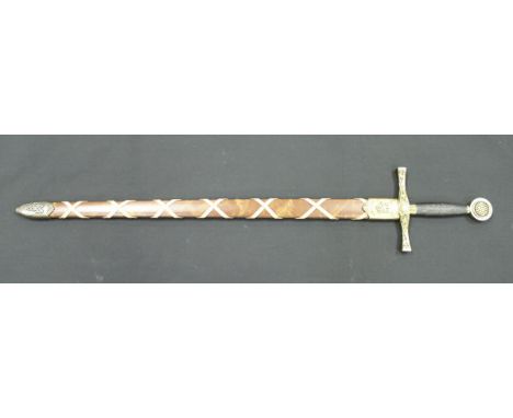 A modern sword, the pommel and scabbard inscribed "Excalibur"