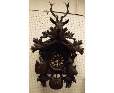 A Black Forest type carved cased cuckoo clock with Swiss musical movement playing "Lara's Theme" from Dr Zhivago, the West Ge