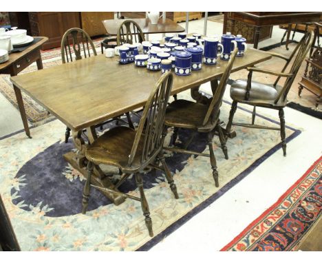 A modern refectory style oak dining table on lyre end supports, 182cm x 89cm, together with a set of six stick back dining ch