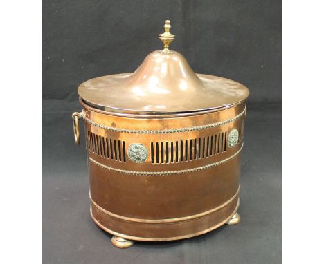 A 19th Century copper and brass mounted lidded coal box of oval form with ring handles, pierced decoration and raised on four
