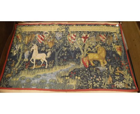 A large wall-hung tapestry depicting the arms of certain Knights of the Round Table with unicorn and lion in foreground in a 