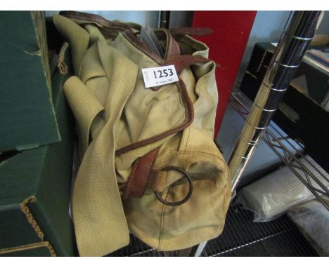 A canvas fishing bag with contents including tins of flies, scales, line, etc     