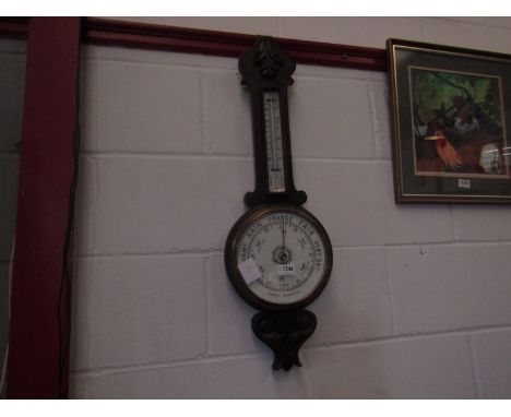 An oak aneroid barometer/thermometer