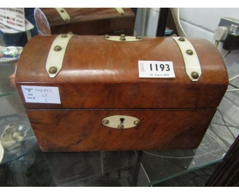 A Victorian walnut domed top tea caddy with ivory banding, twin compartments to interior      