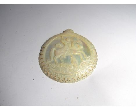 A mother-of-pearl ornately carved token depicting St George and the Dragon, Bethlehem, 11.5cm diameter  