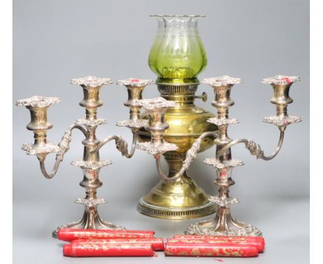 A pair of plated two branch candelabra and a brass oil lamp (3)