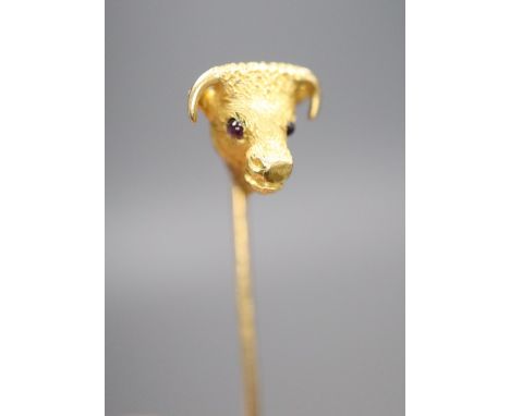 An Edwardian yellow metal and garnet set 'bull's head' stick pin, 65mm, gross 4.4 grams.CONDITION: Overall condition is good.