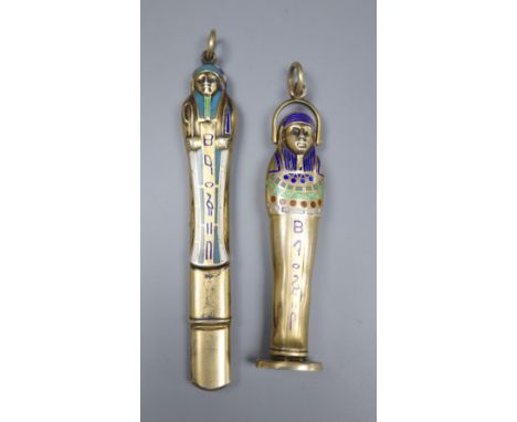 An early 20th century Egyptianesque gilt white metal and enamel propelling pencil/seal, 59mm and a similar pencil case, 72mm.