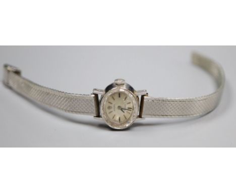 A lady's 18ct gold Rolex precision manual wind oval wrist watch, on a rhodium bracelet, overall 19cm, gross 26.8 grams.CONDIT