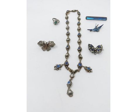 A collection of white metal jewellery. Including a blue paste and blister pearl white metal necklace with a carved Eagle pend