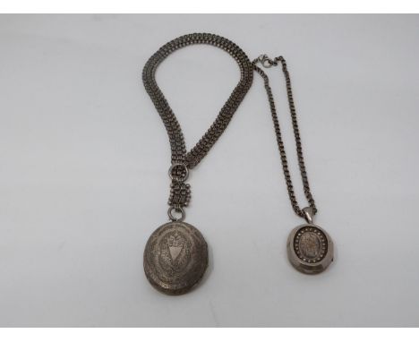 Two Victorian white metal book chains with lockets. One with a wide intricate book chain that attached to a large oval locket