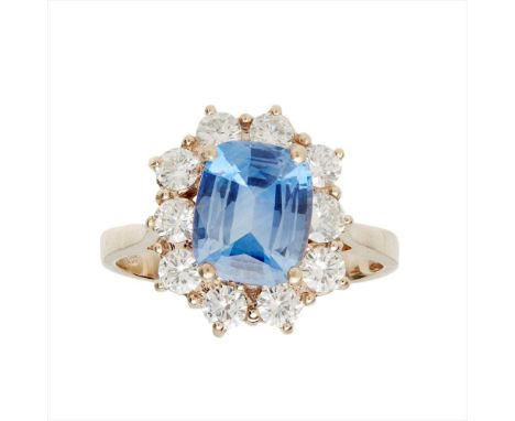 An 18ct gold sapphire and diamond set cluster ring claw set with a cushion-cut sapphire, in a border of round brilliant-cut d