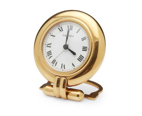 A desk alarm clock, Must de Cartier of circular form, bold rounded bezel, circular dial plain with Roman numerals, strut supp