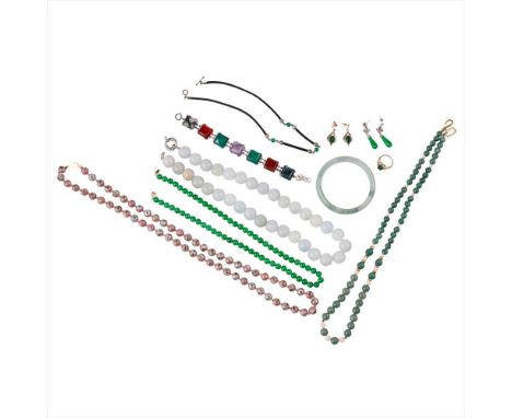 A collection of Asian inspired jewellery to include a jade bangle, various green hardstone and jade beaded necklaces, a hards