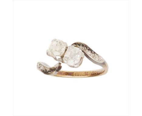 A two stone diamond set twist ring claw set with two old cushion-cut diamonds, the scrolling shoulders with textured detail, 