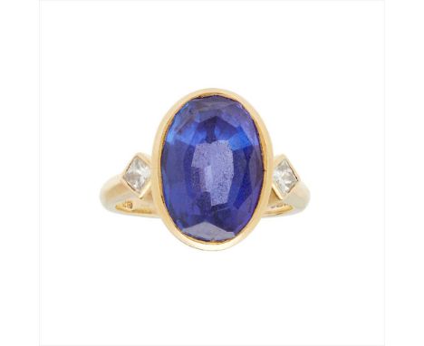 A Tanzanite and diamond set ring, Boodle &amp; Dunthorne collet set with an oval-cut Tanzanite, flanked to either side by a c