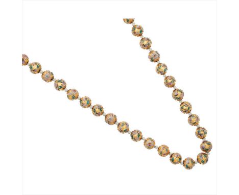 A gilt metal and enamelled bead necklace composed of a single row of gilt metal balls, each with applied enamel floral design