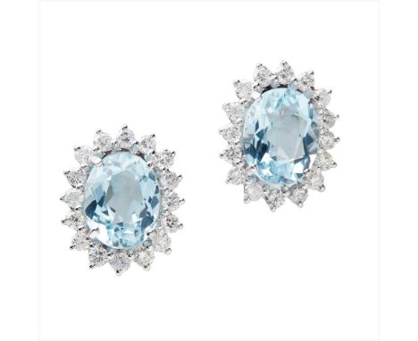 A pair of aquamarine and diamond set cluster earrings each claw set with an oval mixed-cut aquamarine, in a border of round b