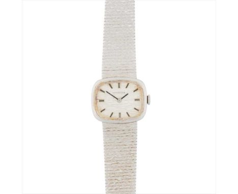 A lady's 9ct gold wrist watch, Longines 1970s/80s, the textured metal dial of rounded rectangular form, baton indicators, int