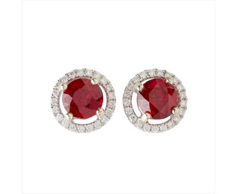 A pair of ruby and diamond set cluster earrings each claw set with a round-cut ruby, in a border of round brilliant-cut diamo