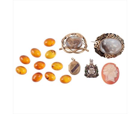 A collection of jewellery to include a mourning brooch of moulded oval form with a black scrolling enamel border, the glazed 