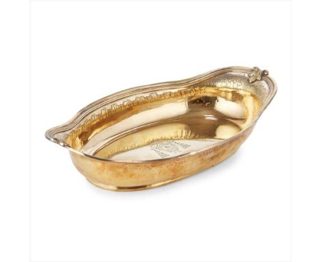 An Italian 18th century silver gilt dish indistinctly marked, of shaped oval form, moulded leaf clasped border, engraved grap