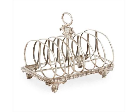 A William IV seven bar toast rack London 1834, of rounded rectangular outline with a gadrooned border, the central oval ring 