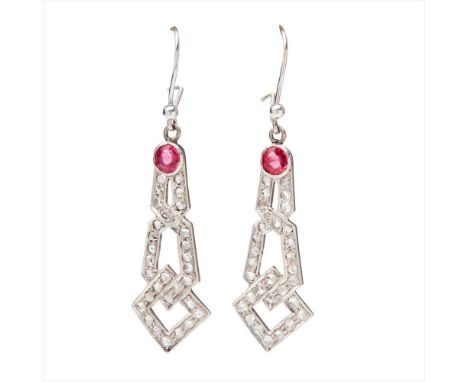 A pair of ruby and diamond set pendant earrings collet set with a round-cut ruby, suspending an open interwoven geometric mot