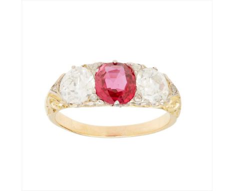 A three stone ruby and diamond set ring claw set with an oval-cut ruby, flanked to either side by a small old round-cut diamo