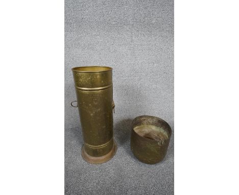 Two brass items. Including a brass cylindrical stick stand with lion head handles and an antique Indian engraved cachepot dec