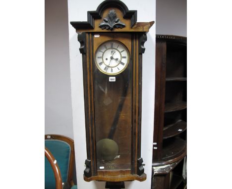A Circa 1900 Vienna Wall Clock, ebonised arched pediment and foliate motif, white enamel dial, Roman numerals.