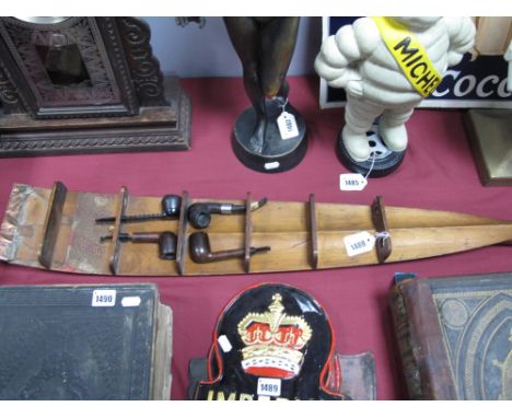 A Pipe Rack, made from an oar, holding Kaywoodie, Petersons and two other pipes.