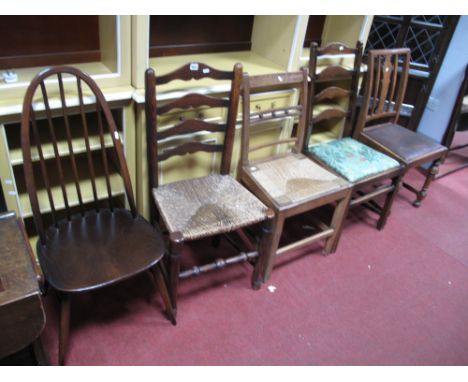 An Ercol Dark Elm Stick Back Dining Chair, a Country rush seated ladder back chair and three other chairs. (5)