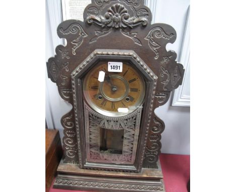 A Late XIX Century American Ansonia Mantel Clock, with shaped top, glazed door, with bead decoration on stepped base.