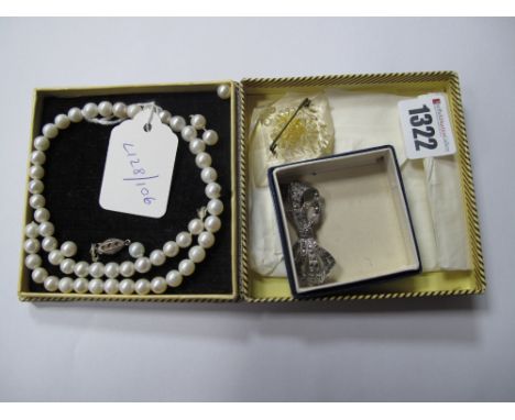 An Art Deco Style Pendant, of elongated design with marcasite set highlights; together with a pearl bead necklace (string bro