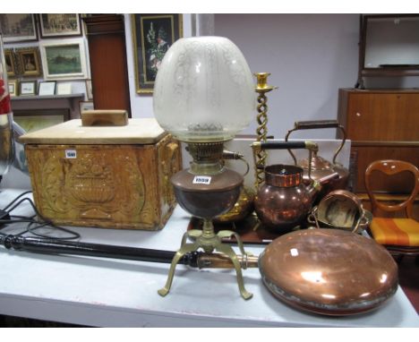 An Early XX Century Paraffin Lamp, copper reservoir, raised on four brass splayed feet, with shade, and a copper warming pan,