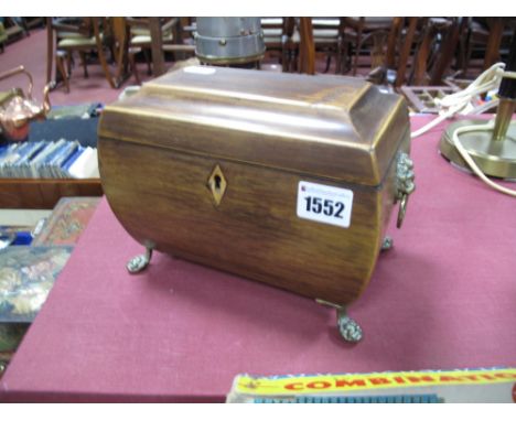 An Early XIX Century Mahogany Tea Caddy, of bowed sarcophagus form, boxwood stringing and escutcheon, twin brass lion mask ha
