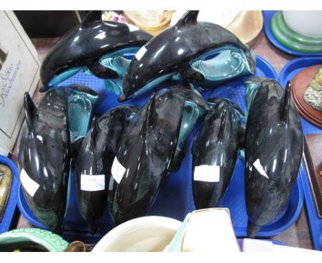 A Collection of Five Poole Pottery Dolphins, in turquoise and black glazes, printed marks, 27cm long and two matching 22cm lo