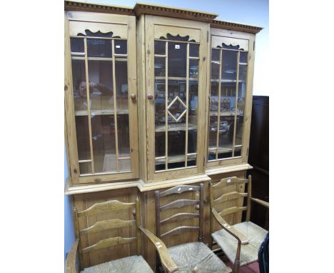 A Pine Breakfront Cabinet, dentil cornice over triple glazed doors, with interior shelving, each over cupboard doors, bracket