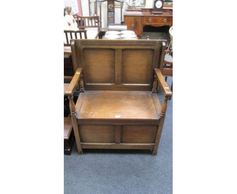 An early 20th century oak and plywood panelled monk's bench