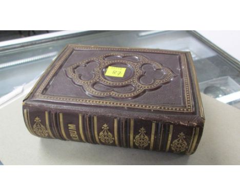 A Victorian gilt metal mounted embossed leather carte de visite photograph album, containing portrait studies by Monsr Louis 
