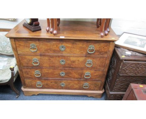 A late 18th/early 19th century continental walnut commode, fitted four long drawers with elaborate cast handles, raised on ca