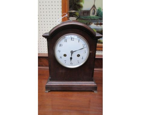 A late 19th century oak cased mantel clock, the arched case enclosing an eight-day gong striking movement, faced by enamel Ar