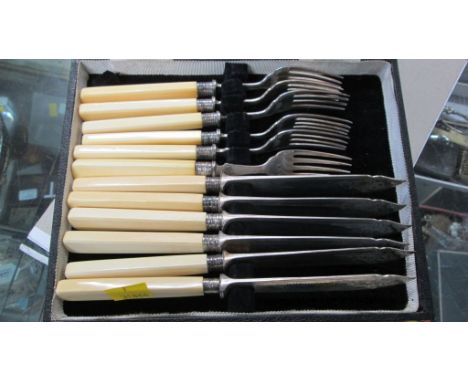 William Hutton and Sons, a cased set of six ivory handled silver fish knives and forks