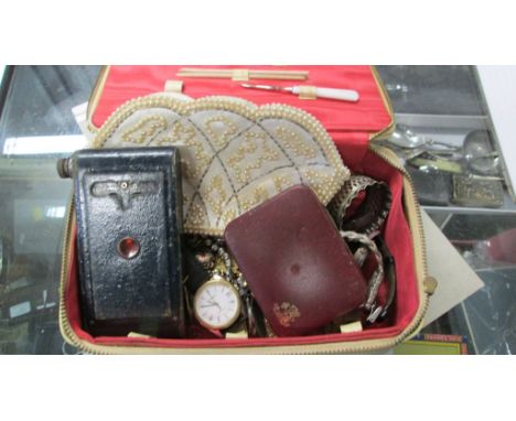 A 1950s jewellery case, containing various costume and paste-set jewellery, wrist watches, a beadwork purse, and a Kodak pock