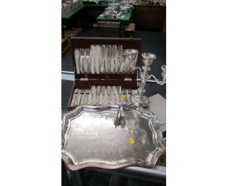 A silver plated tray, a silver plated three branch candelabra, a cased set of twelve silver plated fish eaters (one fork defi