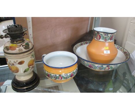 A 1920s pottery jug and bowl, a chamber pot and a pottery oil lamp